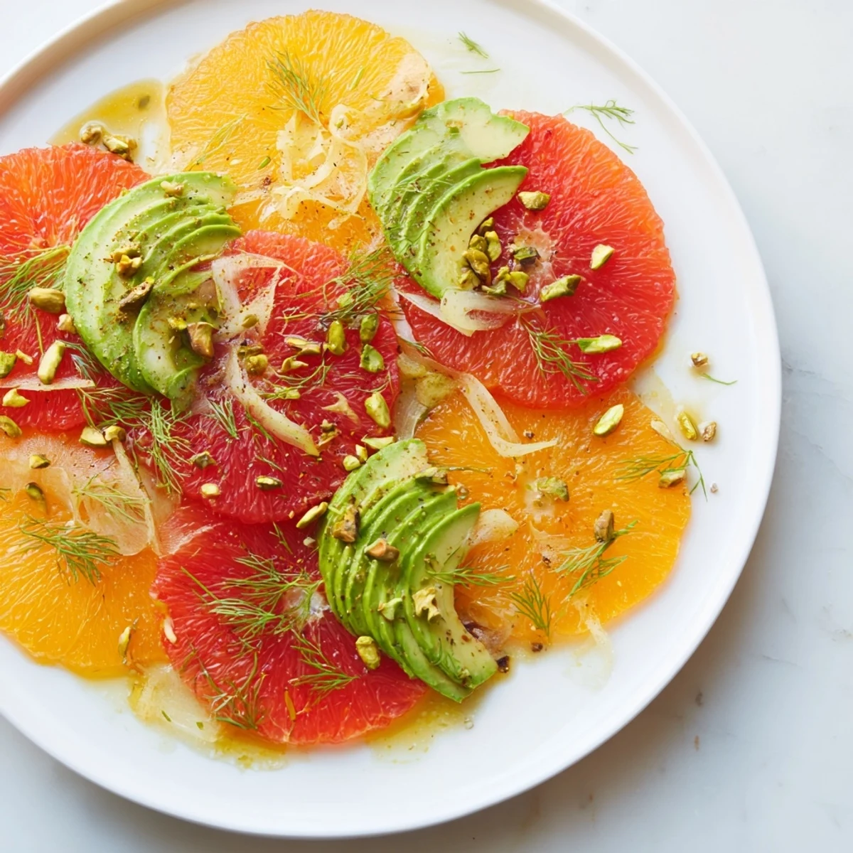 Colorful segments of blood orange and grapefruit top a bed of shaved fennel and creamy avocado.