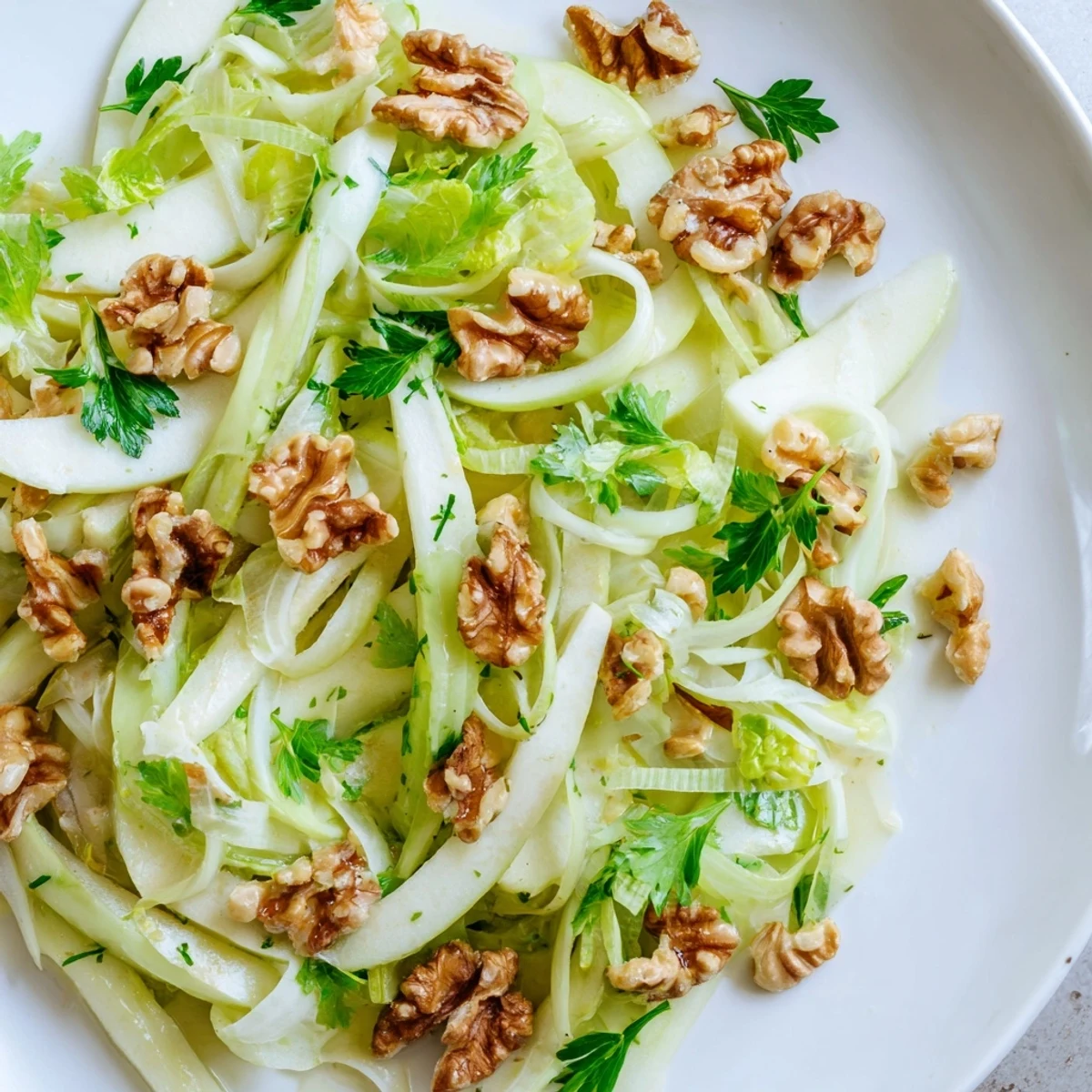 Freshly sliced apples and crisp celery tossed in a light lemon dressing, topped with toasted walnuts in this Apple and Celery Salad with Walnuts.