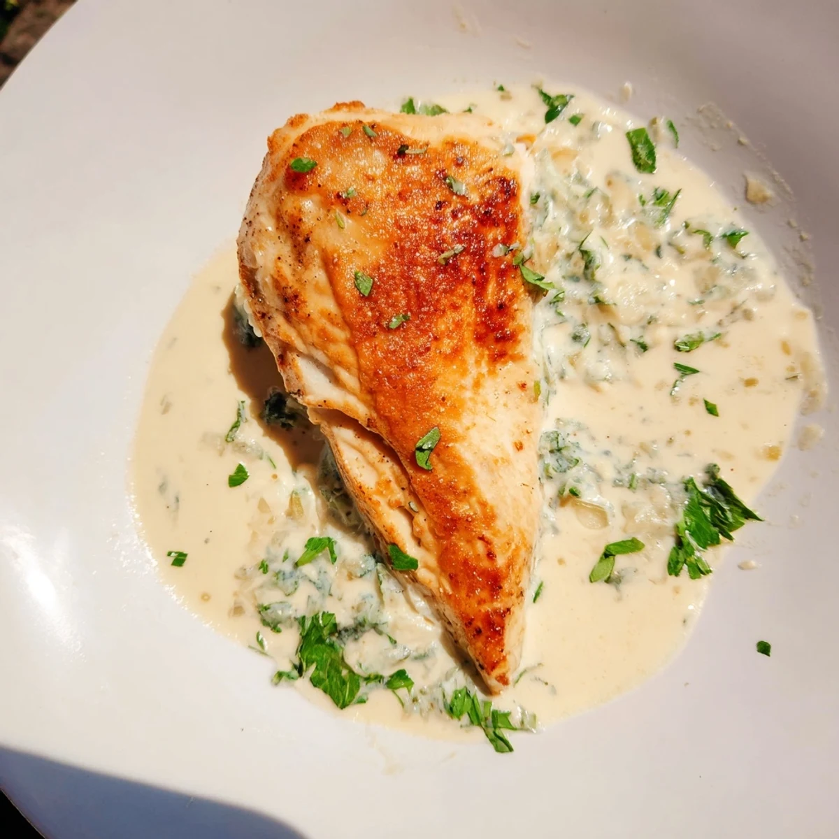Golden-brown chicken breasts smothered in creamy Boursin Chicken sauce with fresh parsley garnish.