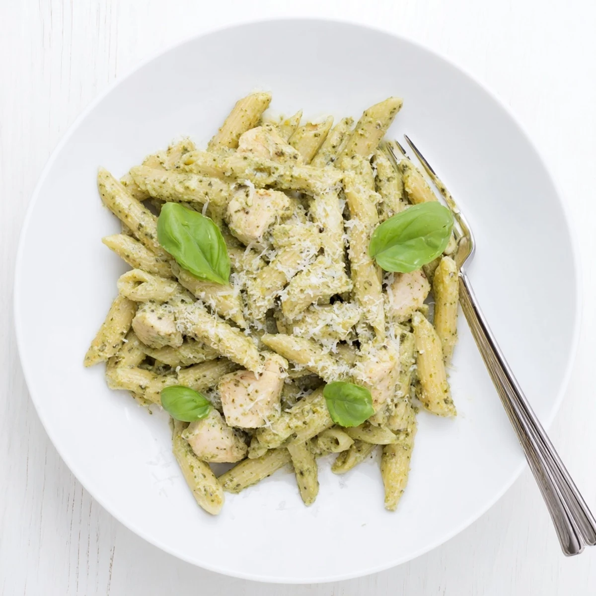 A comforting bowl of Creamy Pesto Chicken Pasta served hot, showcasing tender chicken and creamy basil sauce coating every noodle, ready for a weeknight dinner. 