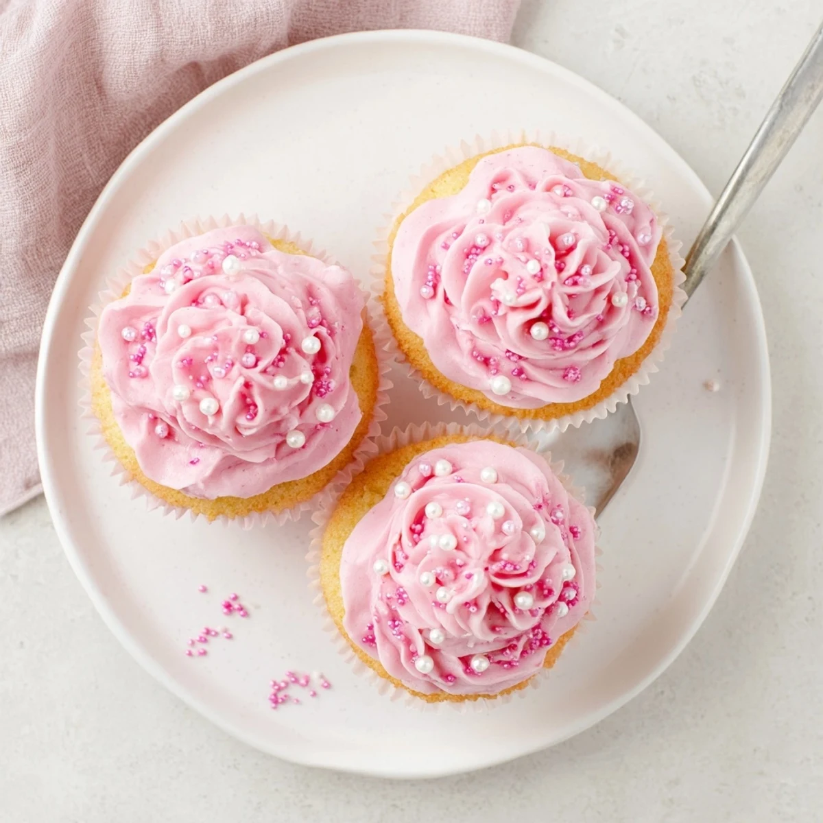 Close-up of a Girl Baby Shower Cupcake showcasing swirled buttercream, pink hues, and subtle sprinkles for a sweet display.