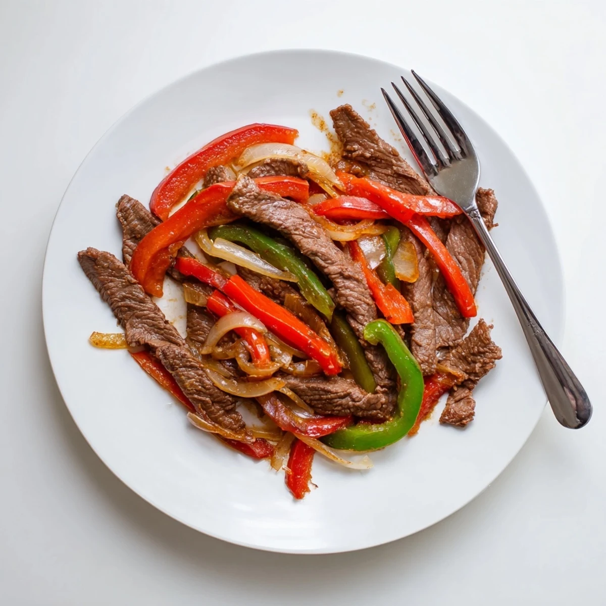 Tender beef strips in Sizzling Chinese Pepper Steak With Onions glazed in a savory peppery sauce.