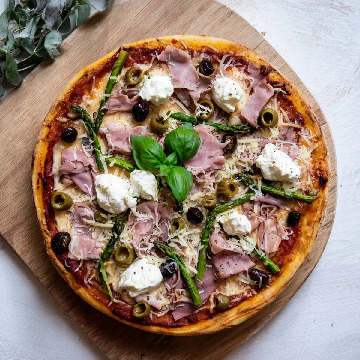 Golden crust topped with smoky ham, tender asparagus, briny olives, and creamy dollops of ricotta for this Ham, Olive, Asparagus, and Ricotta Pizza.
