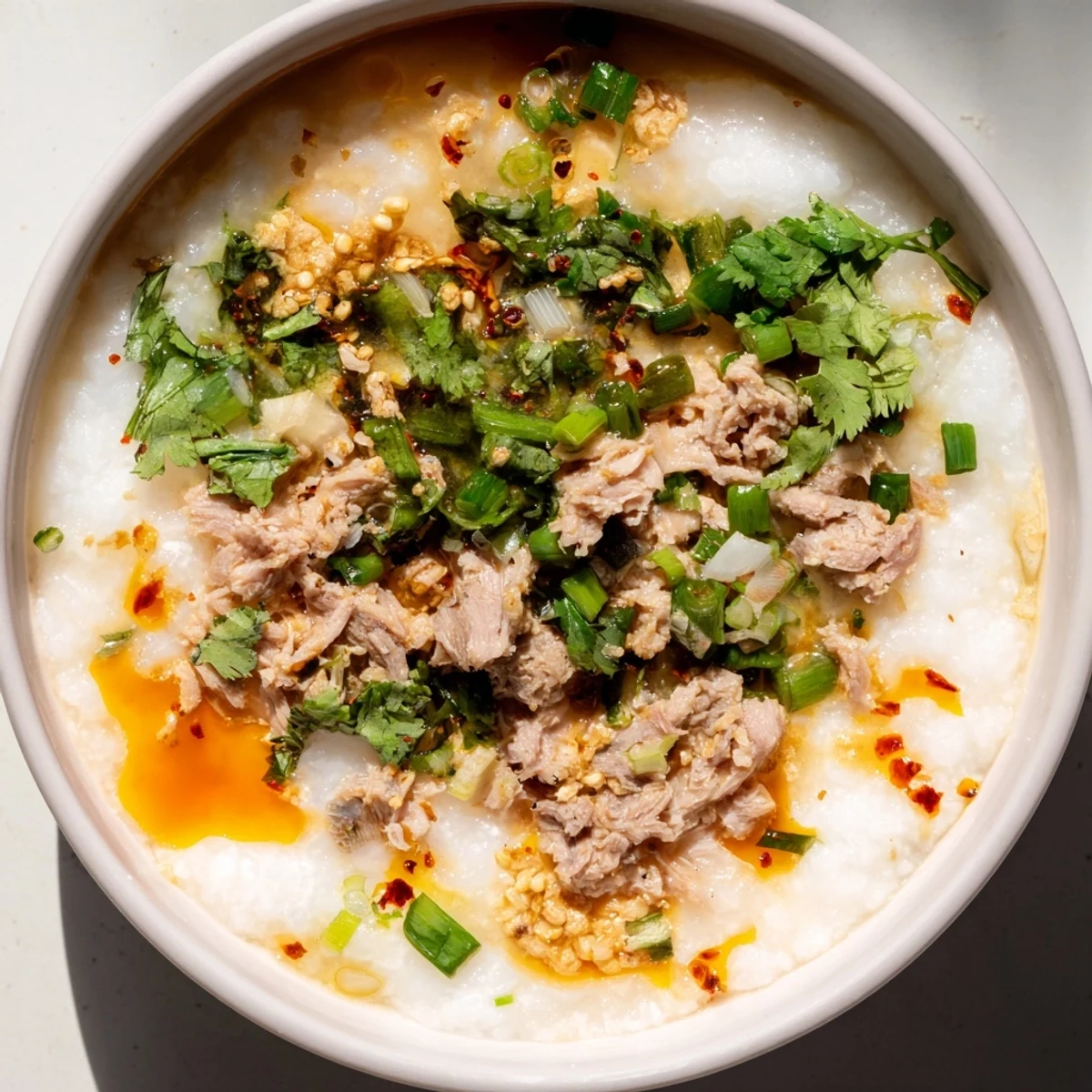 Comforting rice porridge featuring shredded holiday turkey simmered with ginger in a rich aromatic broth