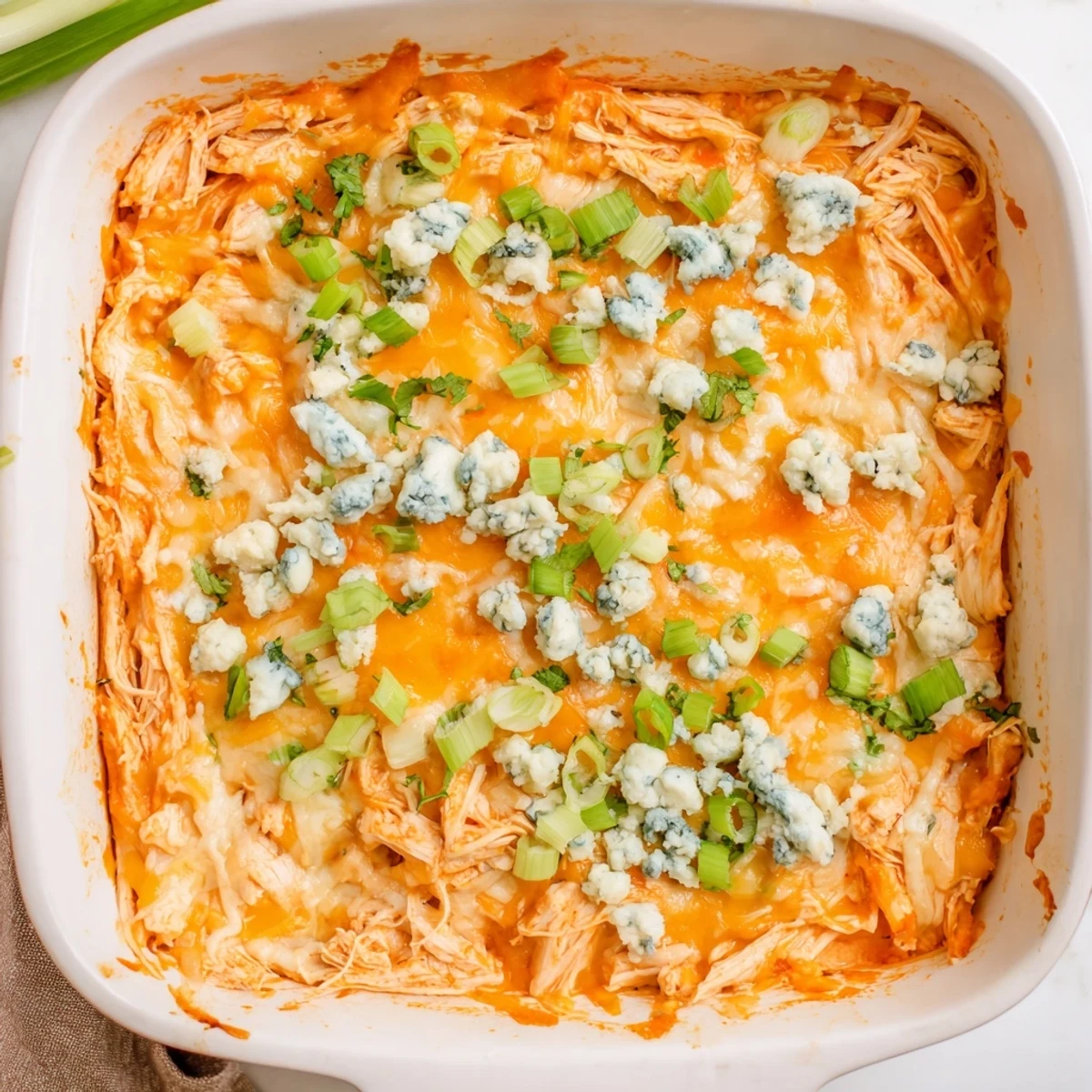 Spicy Buffalo Chicken Cheese Bake served with green onions and blue cheese crumbles