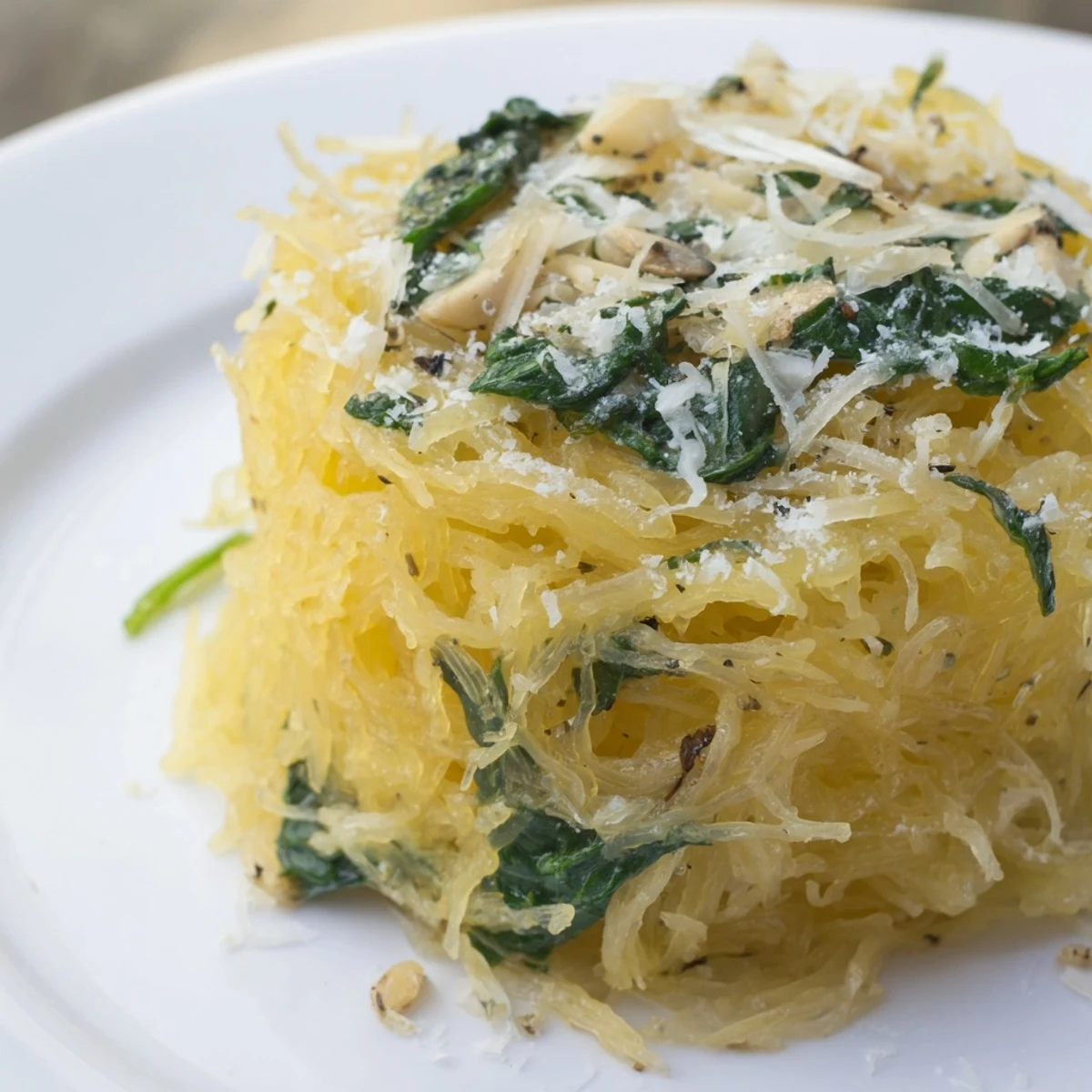 Golden baked Boursin spaghetti squash strands tossed with melted garlic herb cheese and wilted spinach