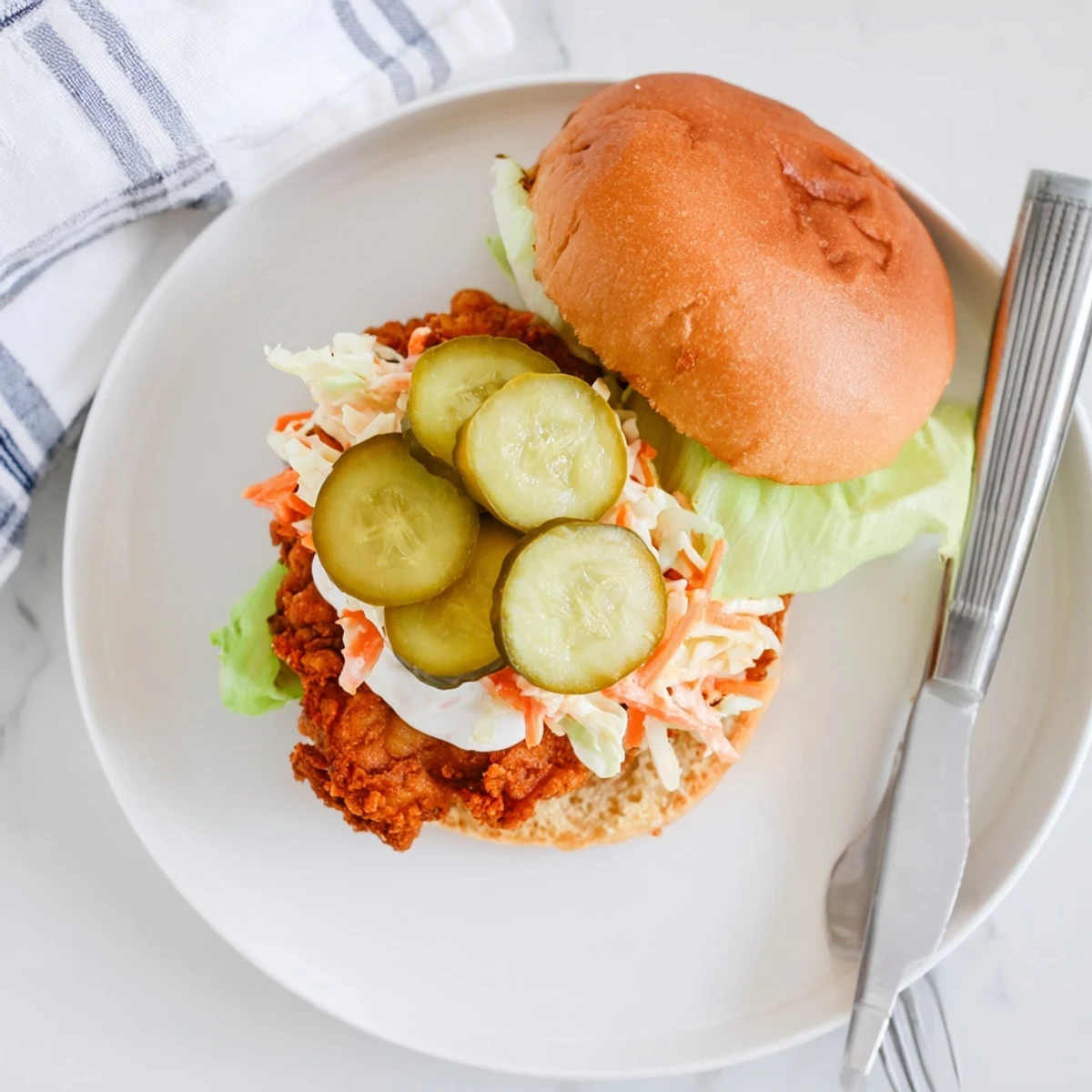 Golden crispy Southern fried chicken burgers topped with tangy slaw and dill pickles