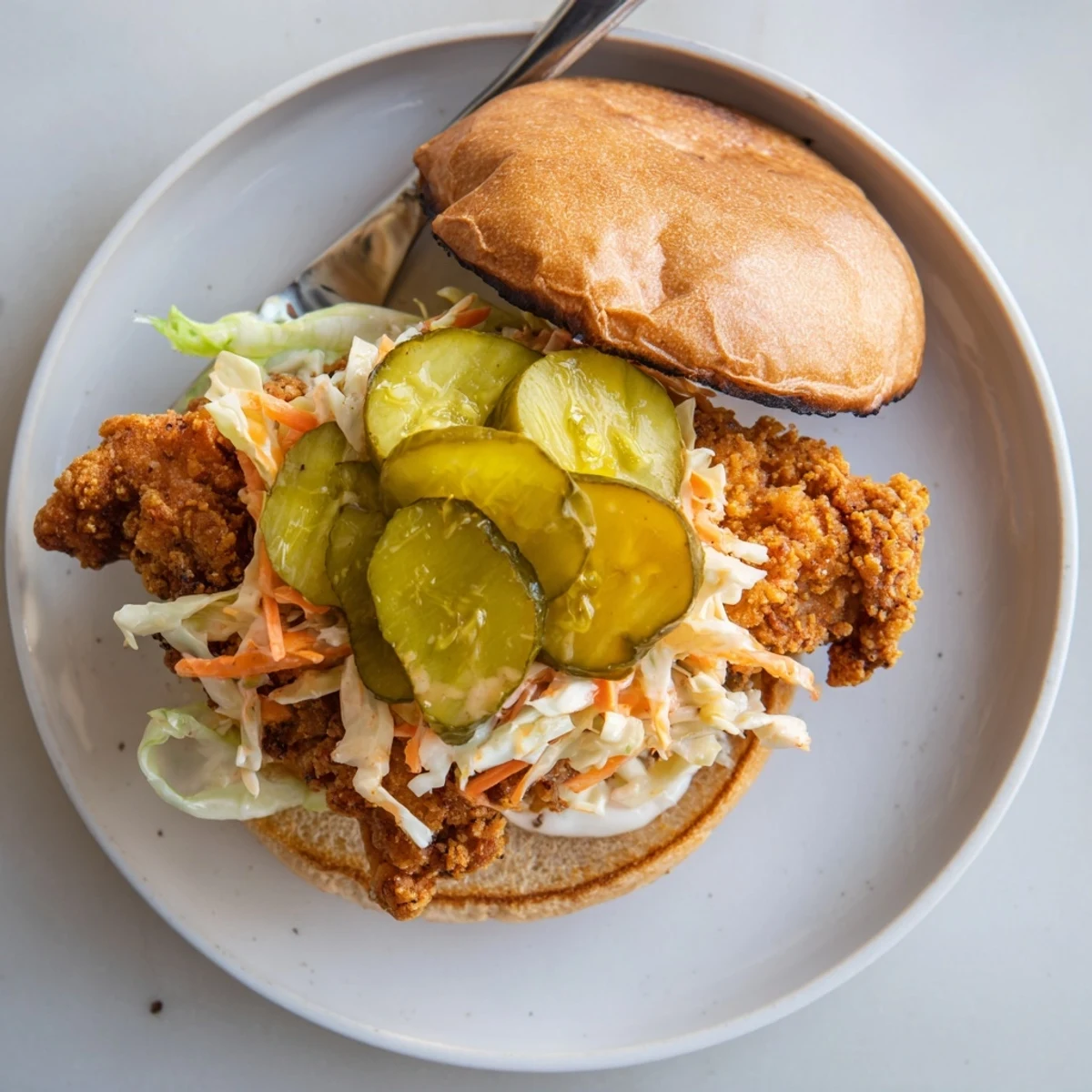 Homemade Southern fried chicken burgers featuring crispy seasoned fillets and fresh coleslaw topping