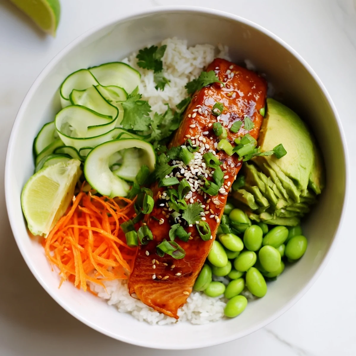 Delicious honey glazed salmon bowl featuring tender fish over rice with fresh cilantro