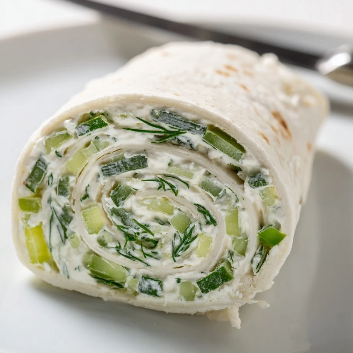 Tasty pickle dip pinwheels appetizer with tangy chopped pickles and herbed cream cheese filling, arranged neatly on a party tray