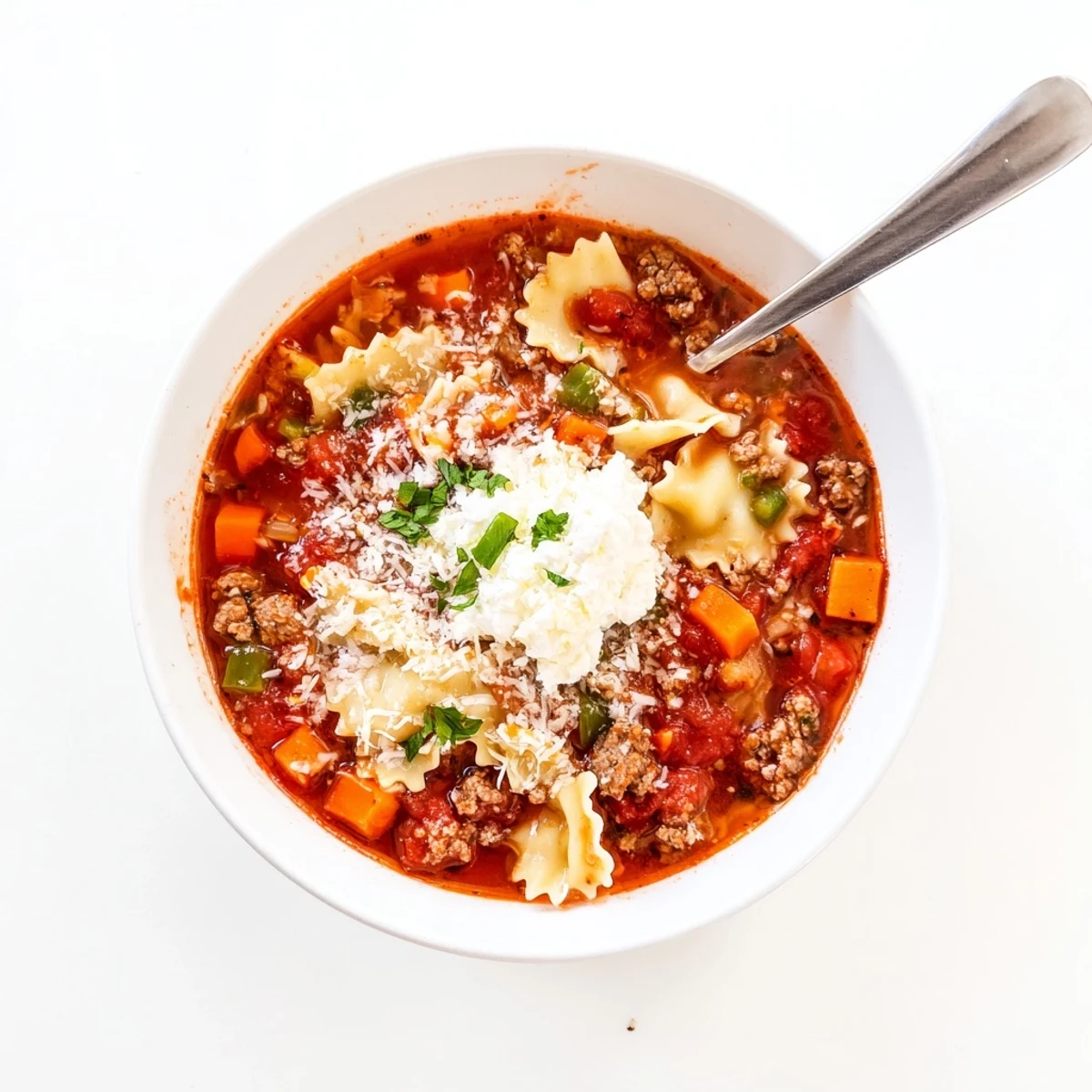 Hearty Italian lasagna soup featuring broken pasta noodles in rich tomato broth with melted cheese
