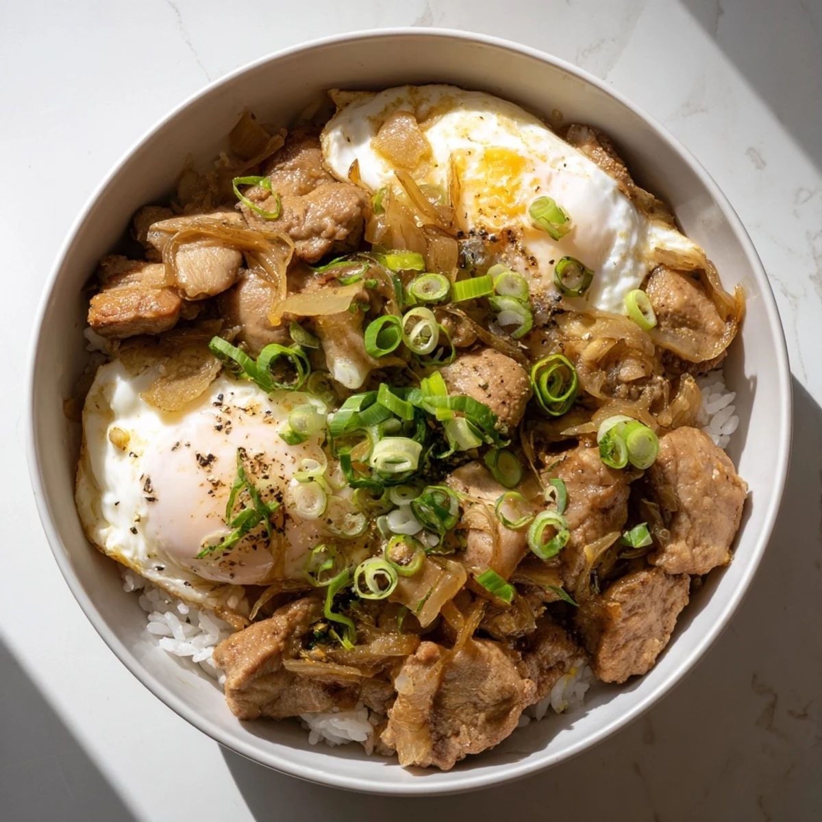 Comforting Oyakodon Japanese rice bowl with savory chicken, onions, and silky scrambled eggs