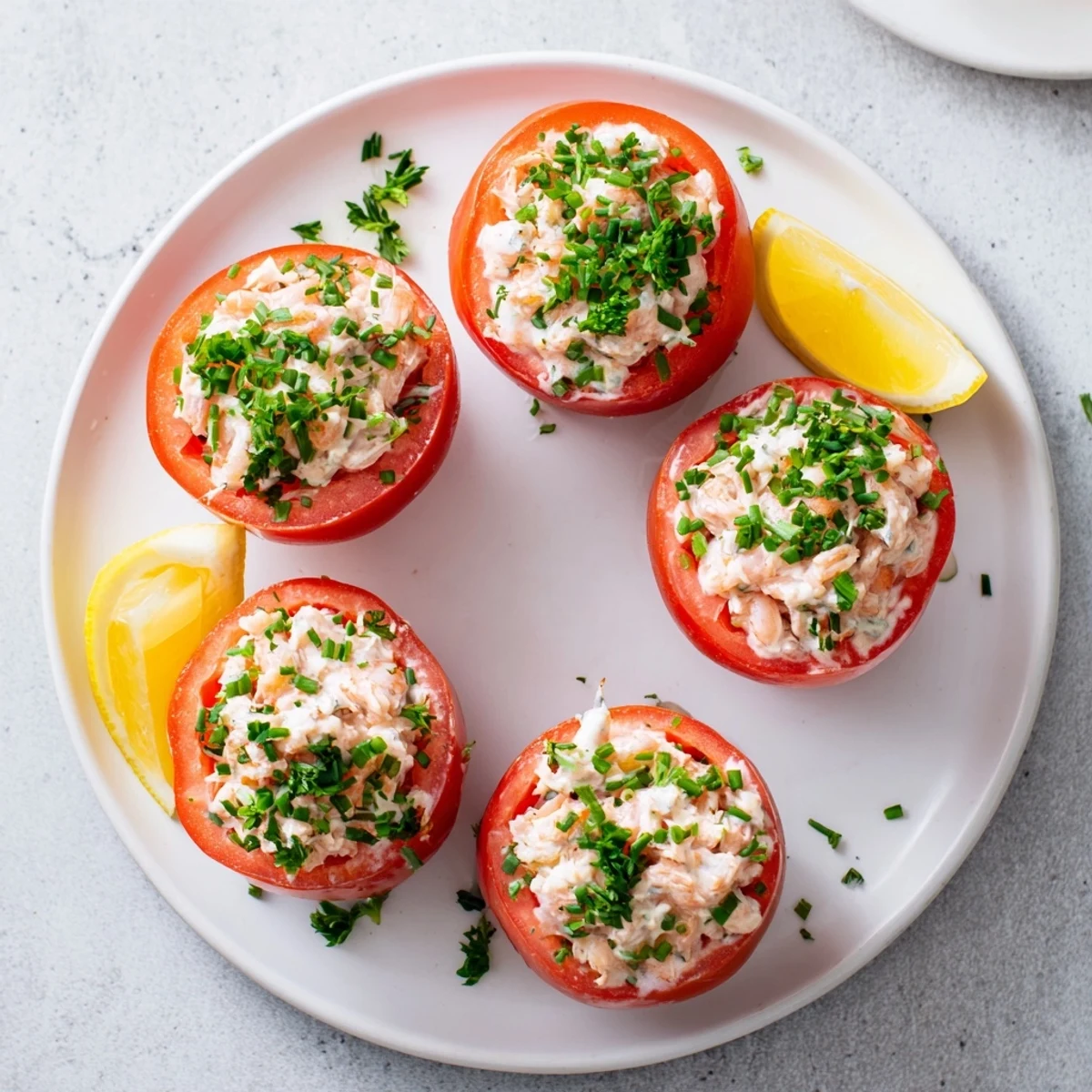 Ripe tomato halves stuffed with North Sea shrimp mayonnaise mixture garnished with chives