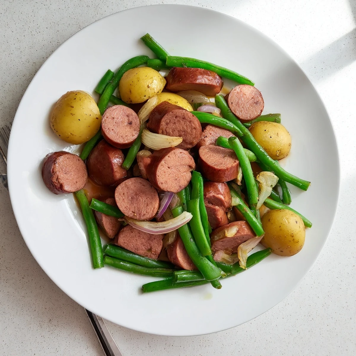 Comforting Crockpot Kielbasa and Green Beans dish with sliced sausage potatoes and aromatic seasonings