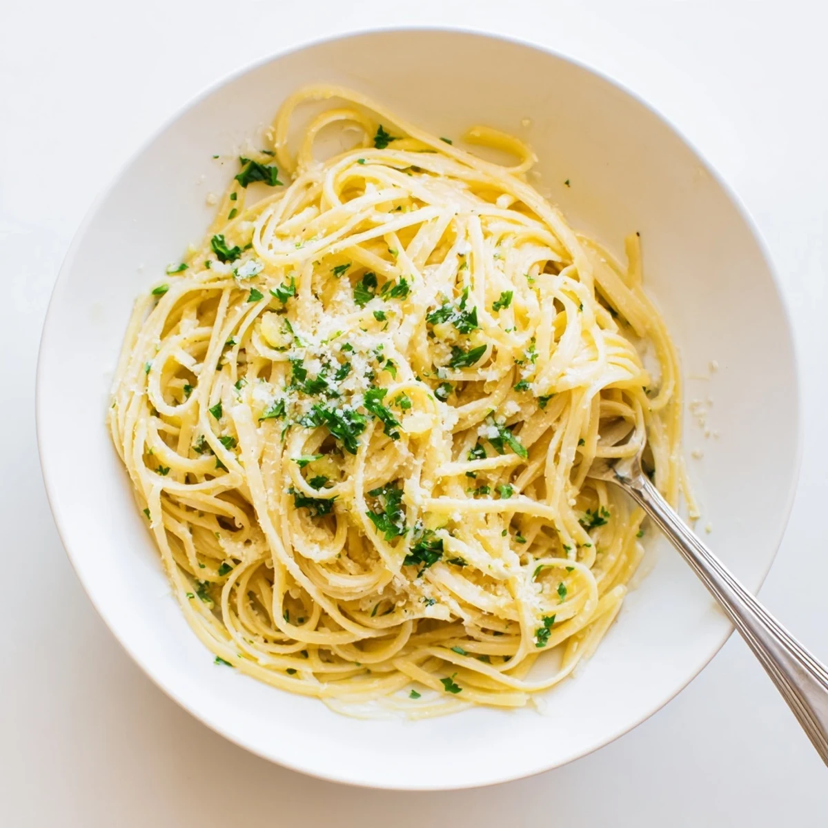 Savory spaghetti noodles tossed in fragrant garlic butter sauce served in a deep rustic bowl