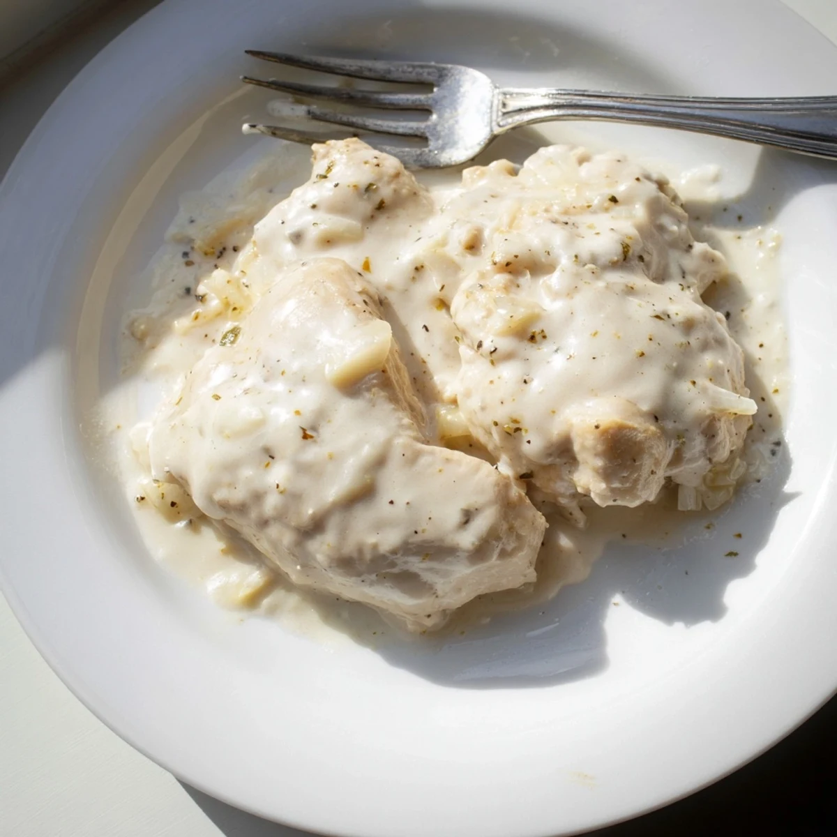 Succulent boneless chicken thighs nestled in a thick savory gravy ready for serving