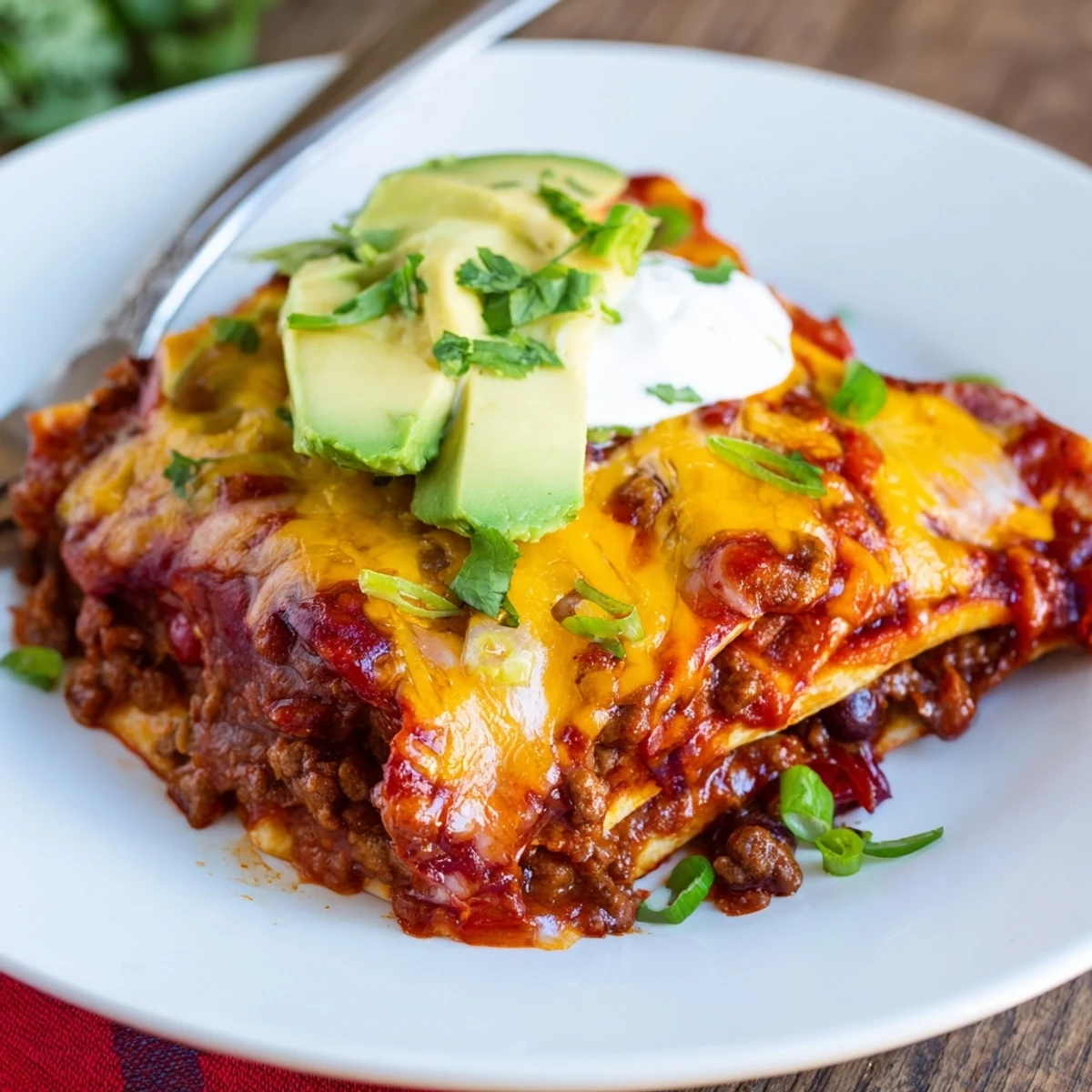 Beef Skillet Enchiladas bubbling in skillet with melted cheese and cilantro