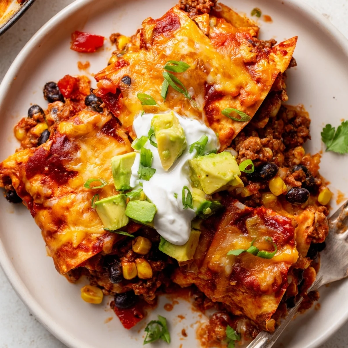 Family-style Beef Skillet Enchiladas served hot from skillet, golden cheese crust