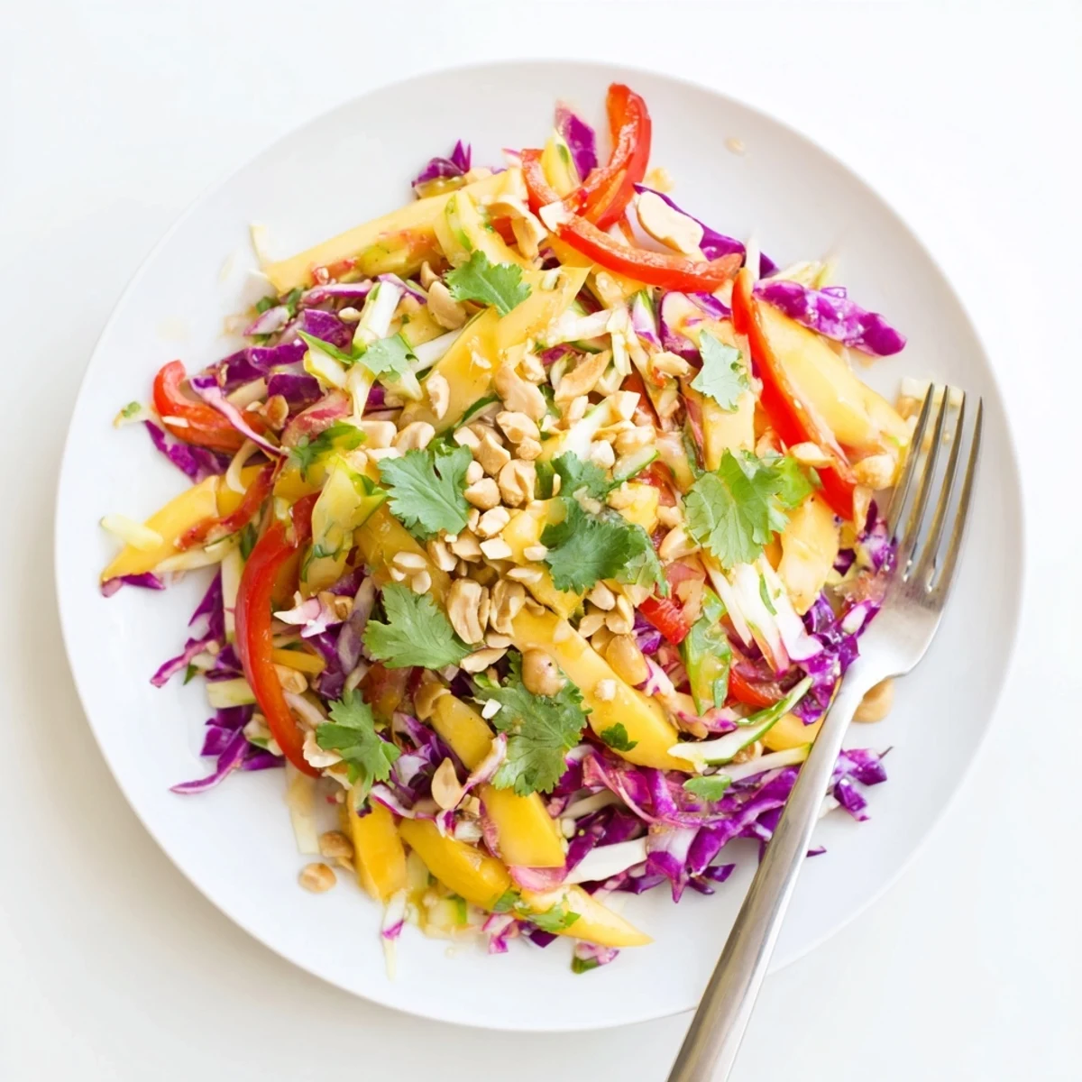 Vibrant tropical slaw featuring sweet mango julienne and colorful crunchy vegetables