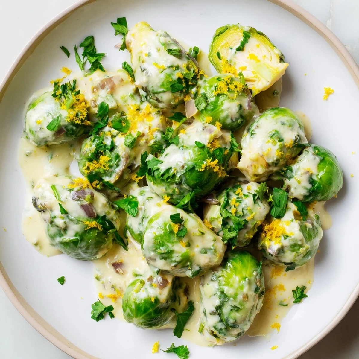 Creamy Boursin cheese smothered Brussels sprouts served in white serving bowl