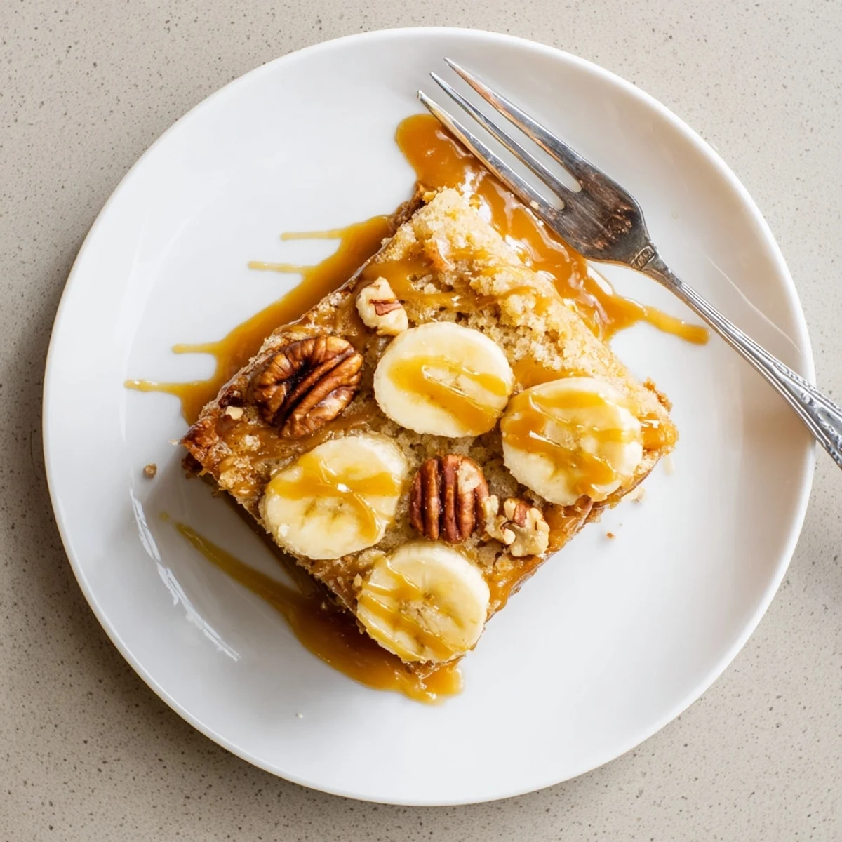 Decadent brown butter banana cake featuring ribbons of golden salted caramel and flaky sea salt