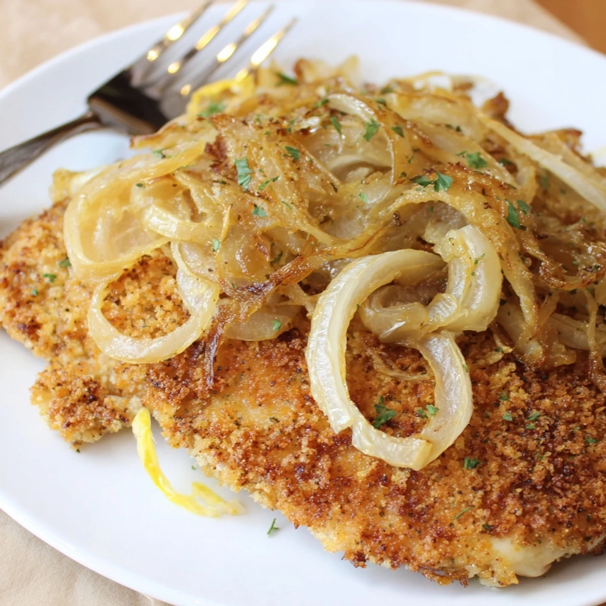 Sliced Crispy Chicken Caramelized Onions Melted Cheese served warm beside salad