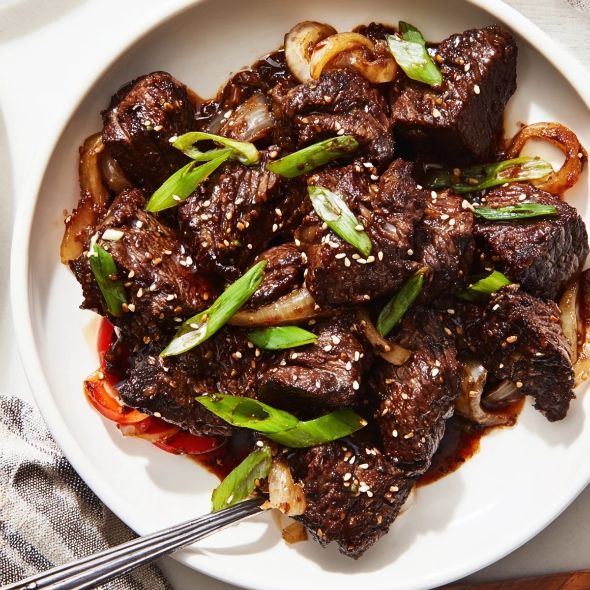 Tender Asian-inspired cube steak glazed in savory soy-ginger sauce with colorful bell peppers