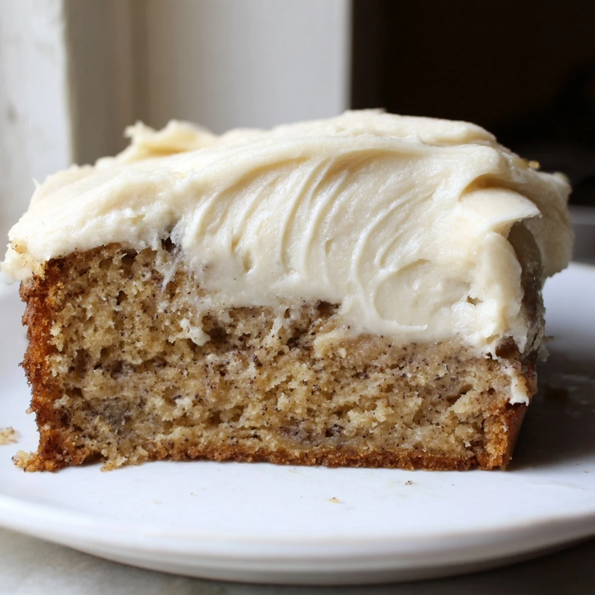 Moist Brown Butter Banana Cake topped with a generous layer of fluffy cream cheese frosting