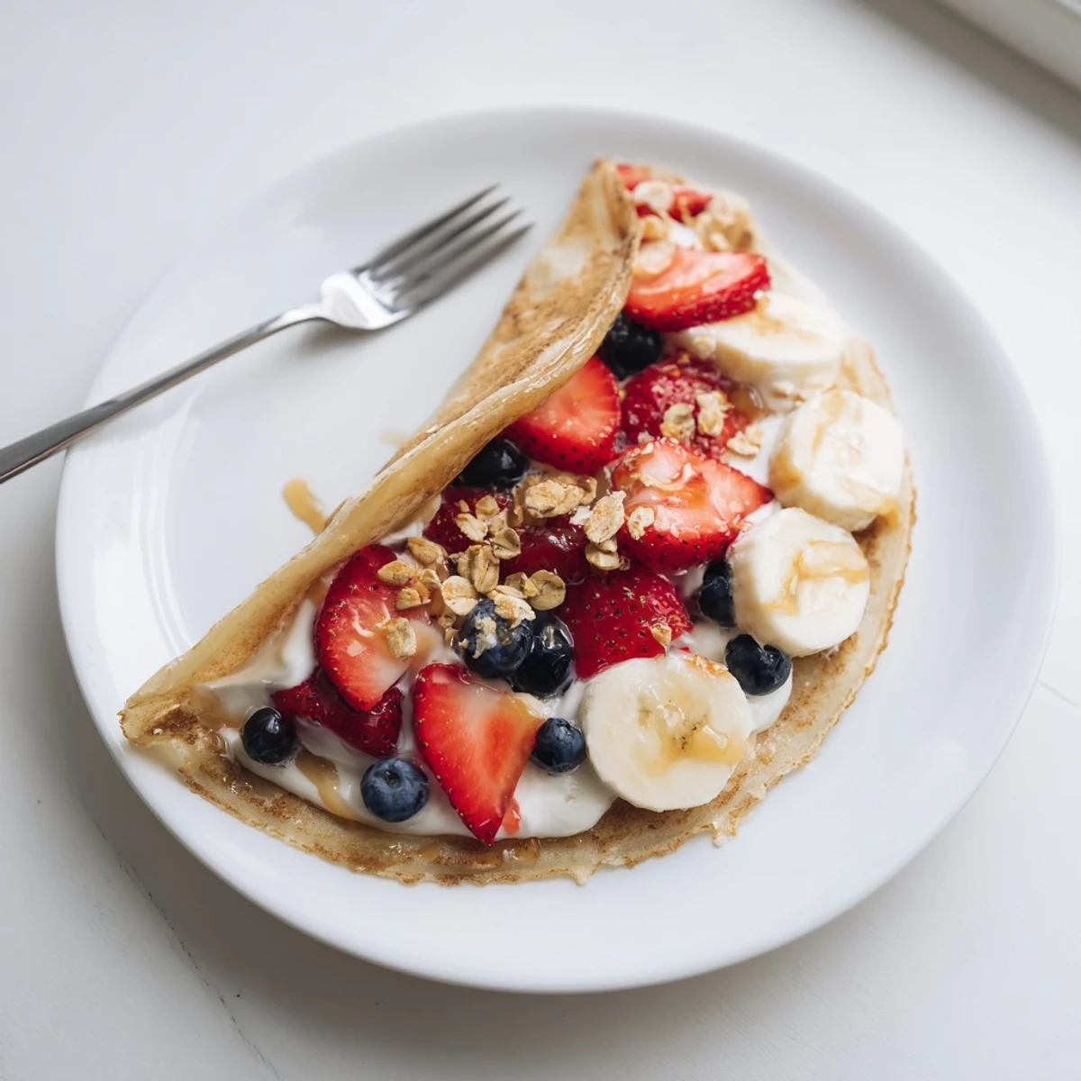 Golden pancake tacos piled high with fresh fruit and syrup for breakfast.