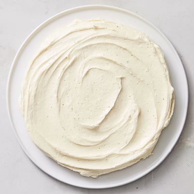 Easy Sugar Cookie Frosting in white and pink swirls, ready to ice iced sugar cookies beautifully.